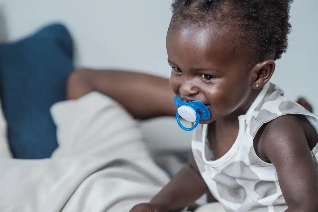 Baby using a pacifier during early childhood