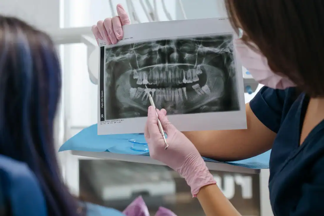Dentist reviewing a dental X-ray with a patient