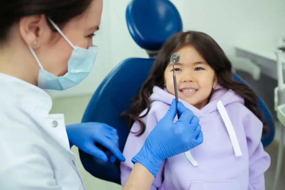 Dentist talking with a child during a comfortable dental visit