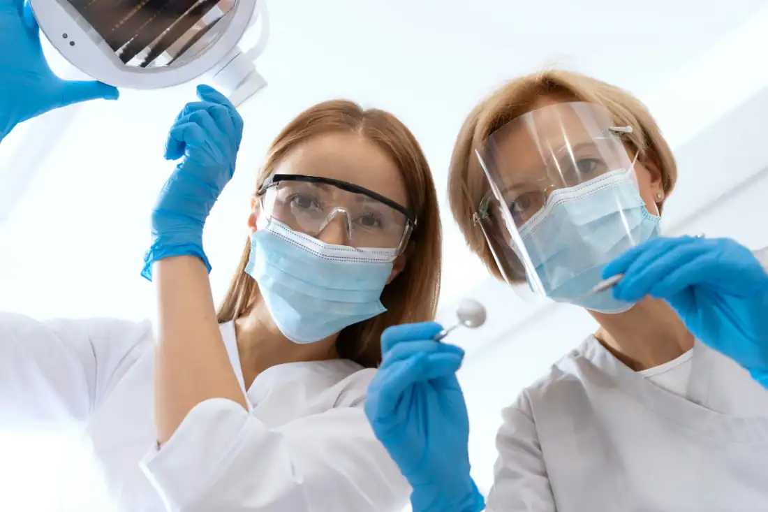 dentists performing dental procedure