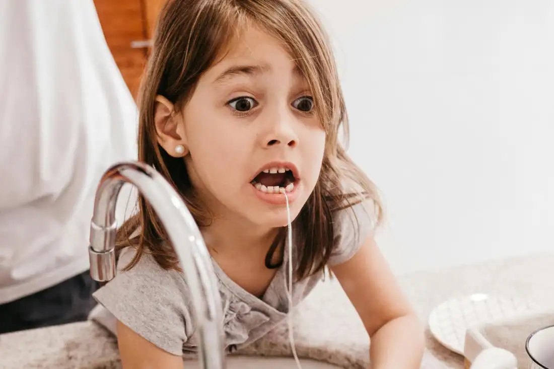 child flossing in the bathroom