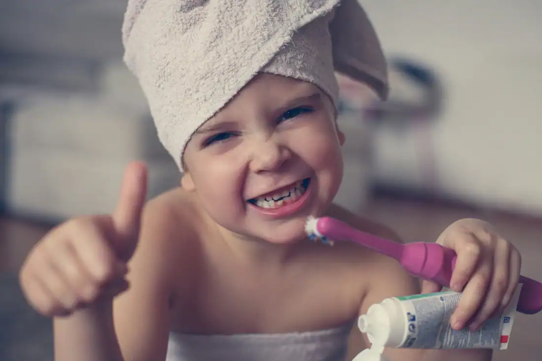 little girl brushing teeth