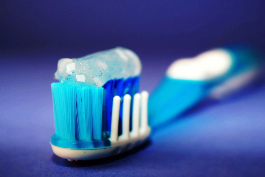 Close-up of fluoride toothpaste on toothbrush.