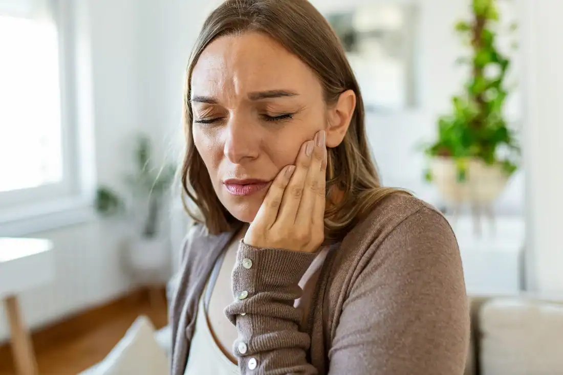 woman in pain from gum issues