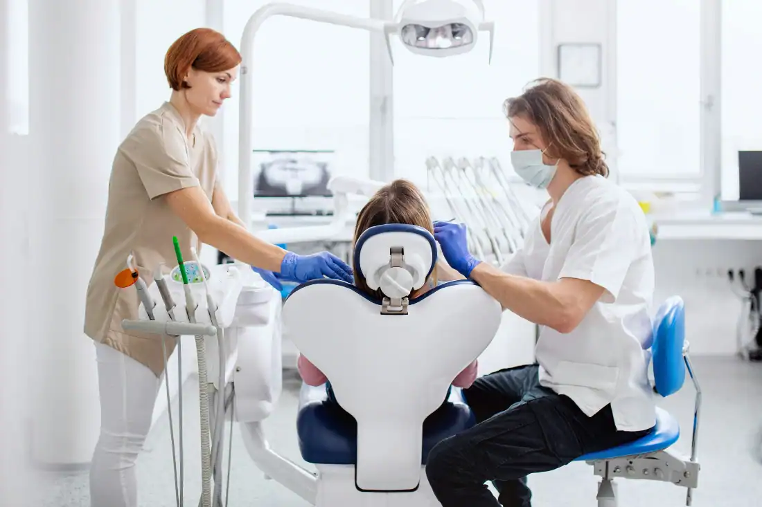 patient, dentist, and dentist's assistant in a dental clinic