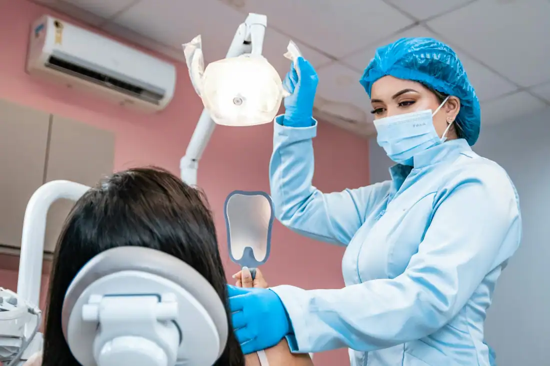 a woman getting her teeth checked by a dentist