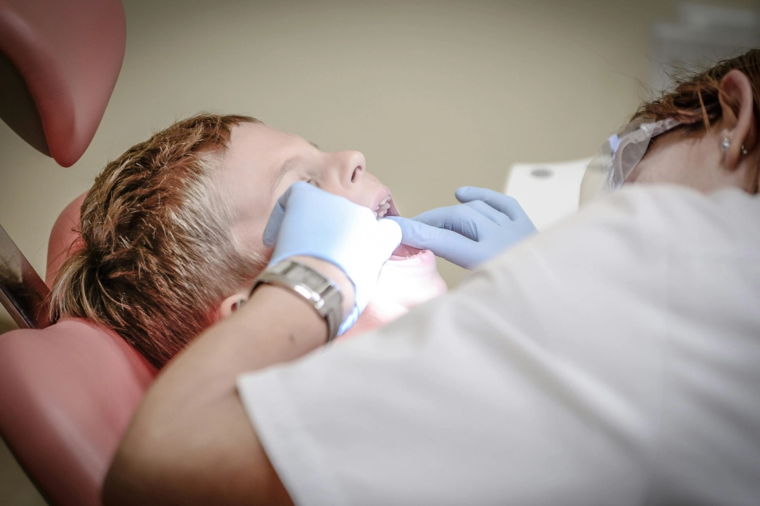 A dentist examining child's tooth decay.