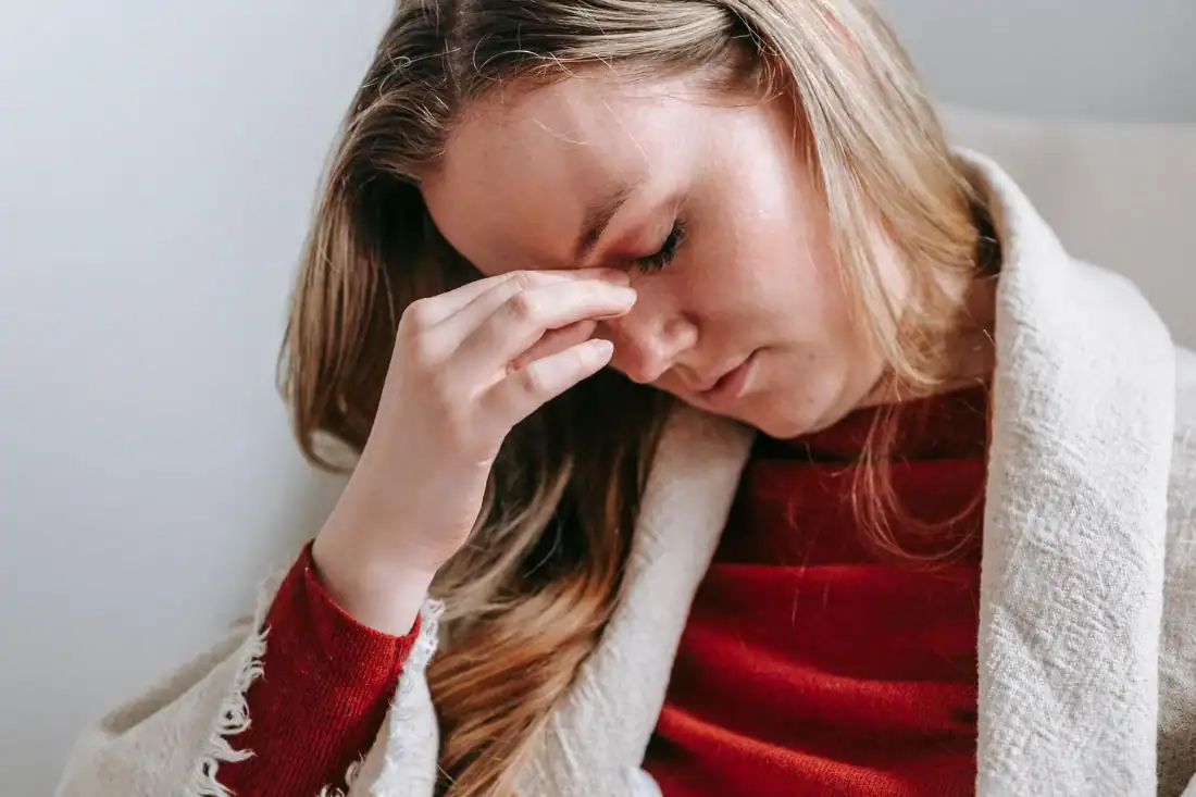 Woman experiencing a headache associated with jaw tension