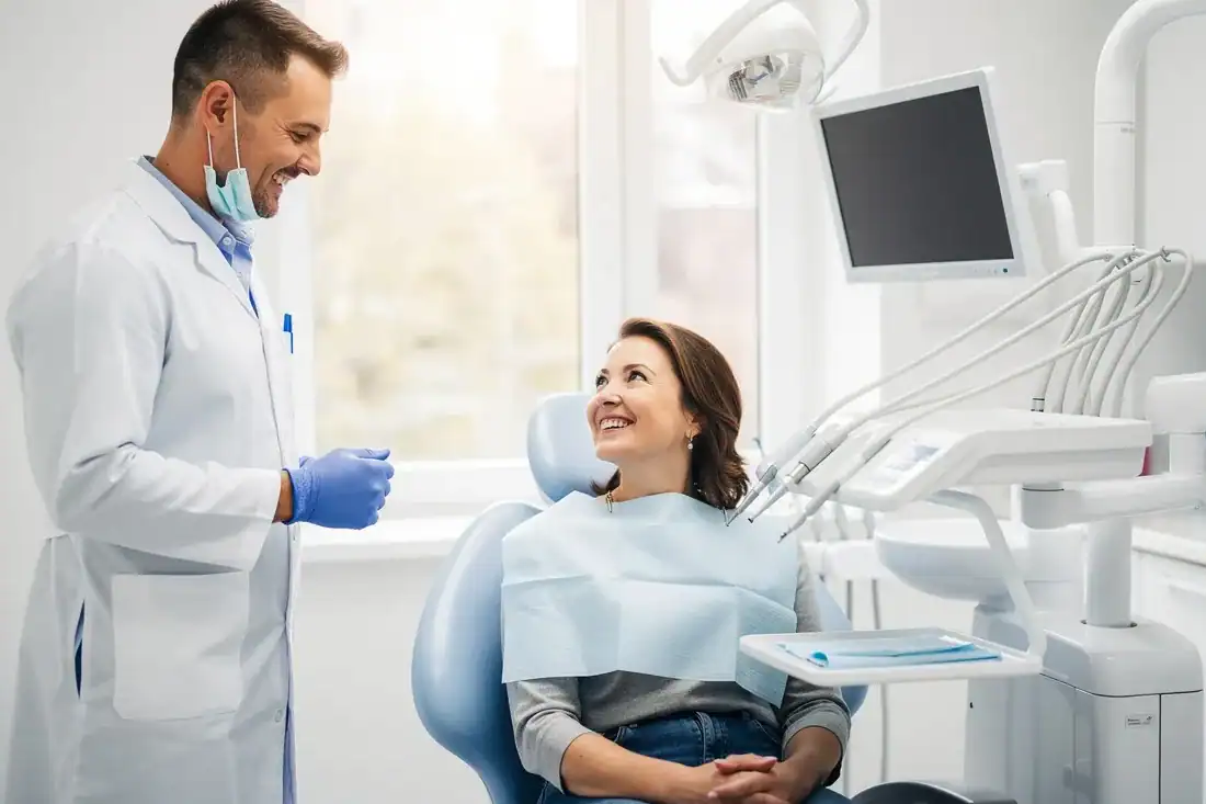 a cheerful dentist engaging in a friendly conversation with a patient