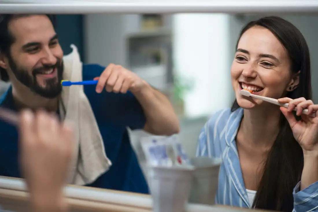 couple brushing teeth