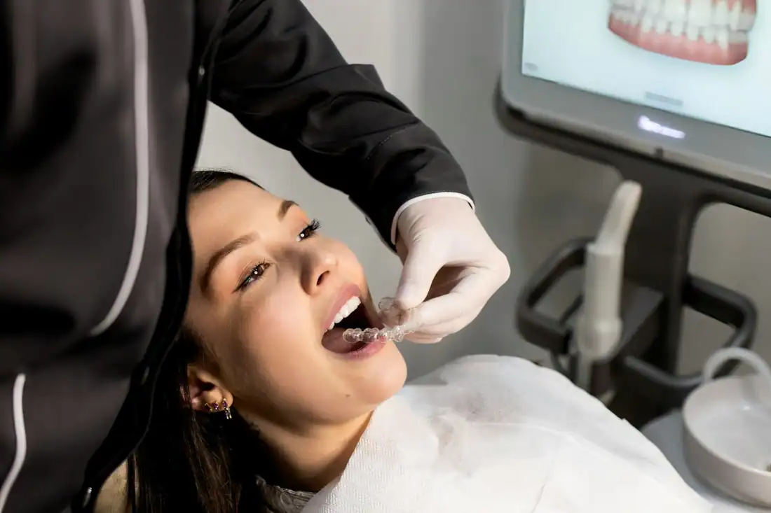 dentist inserting Invisalign aligner