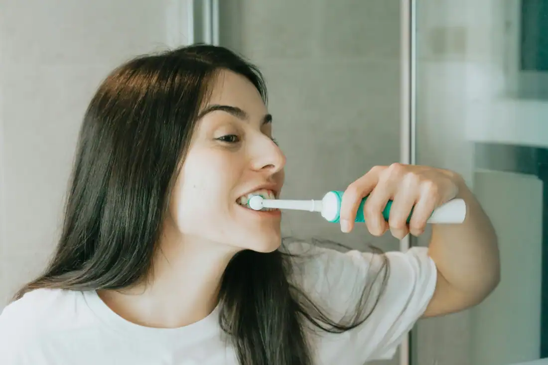 teen brushing her teeth